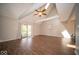 Bright and airy living room featuring a high ceiling, a ceiling fan, and sliding glass doors to the backyard at 11525 Capistrano Cir, Indianapolis, IN 46236