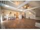 Open-concept living room featuring a high ceiling, ceiling fan, kitchen, and access to the upper level at 11525 Capistrano Cir, Indianapolis, IN 46236