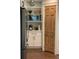 Pantry features built-in microwave, coffee maker, shelving, and beautiful wood door at 11525 Capistrano Cir, Indianapolis, IN 46236