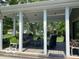 Covered patio with multiple seating areas, ceiling fan, and open view to backyard at 11525 Capistrano Cir, Indianapolis, IN 46236