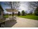 Back patio featuring an umbrella and patio set perfect for outdoor dining and entertaining at 11525 Capistrano Cir, Indianapolis, IN 46236
