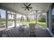 Enclosed porch with ample natural light showcases outdoor views and features sleek flooring and comfortable seating at 11525 Capistrano Cir, Indianapolis, IN 46236