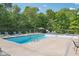 Community pool with lounge chairs, umbrellas, and serene setting at 11525 Capistrano Cir, Indianapolis, IN 46236