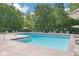Community pool with lounge chairs, umbrellas, and serene setting at 11525 Capistrano Cir, Indianapolis, IN 46236