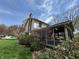 Landscaped backyard with a screened-in porch, mature trees, and blooming bushes, ideal for outdoor living at 1235 Cottonwood Ct, Carmel, IN 46033