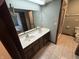 Bathroom with double sinks, wood cabinets, and tile flooring adjacent to a shower and toilet at 1235 Cottonwood Ct, Carmel, IN 46033