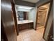 Bathroom with double sinks, wood cabinets and a shower behind a glass door at 1235 Cottonwood Ct, Carmel, IN 46033