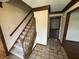 Foyer featuring tile flooring and carpeted stairs at 1235 Cottonwood Ct, Carmel, IN 46033