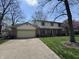 Traditional two-story home boasting a brick facade, attached garage, and lush green lawn at 1235 Cottonwood Ct, Carmel, IN 46033