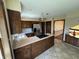 The kitchen features tile floors, stainless steel refrigerator, and breakfast bar with gas stovetop at 1235 Cottonwood Ct, Carmel, IN 46033