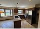 Kitchen with tile floors, stainless steel refrigerator, and breakfast bar with gas stovetop at 1235 Cottonwood Ct, Carmel, IN 46033