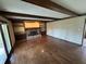 Spacious living room with hardwood floors, ceiling beams, a fireplace, built-in shelving, and door to the deck at 1235 Cottonwood Ct, Carmel, IN 46033