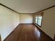 Bright living room with hardwood floors and a large window offering plenty of natural light at 1235 Cottonwood Ct, Carmel, IN 46033