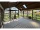 The screened in porch with wood floors, wood ceiling with fan, and a view of the fenced backyard at 1235 Cottonwood Ct, Carmel, IN 46033