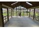 The screened in porch with wood floors, wood ceiling with fan, and great view of the fenced backyard at 1235 Cottonwood Ct, Carmel, IN 46033