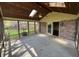 A screened porch with wood flooring, brick accents, ceiling fan, and wood paneled ceiling with skylights at 1235 Cottonwood Ct, Carmel, IN 46033