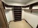 Spacious walk-in closet with multiple shelves and tiered clothes rods for optimal organization at 1235 Cottonwood Ct, Carmel, IN 46033