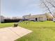 Spacious backyard with green grass, a playset, and a concrete patio with a fire pit at 12723 Pinetop Way, Noblesville, IN 46060