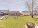 Expansive backyard featuring a playset, lush grass, and a patio area with a stylish fire pit at 12723 Pinetop Way, Noblesville, IN 46060