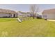 Wide backyard featuring a playset, green grass, and a cozy fire pit area for relaxation at 12723 Pinetop Way, Noblesville, IN 46060