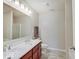 Bathroom with a double sink vanity, large mirror, modern fixtures, and neutral walls at 12723 Pinetop Way, Noblesville, IN 46060