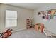 bedroom featuring gray carpet, window, and storage for toys and books at 12723 Pinetop Way, Noblesville, IN 46060