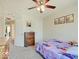 Comfortable bedroom with carpet, ceiling fan, a wooden dresser, and a fun Frozen-themed bedspread at 12723 Pinetop Way, Noblesville, IN 46060