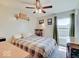 Cozy bedroom with ceiling fan, a large window for natural light, and neutral walls at 12723 Pinetop Way, Noblesville, IN 46060