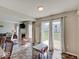 Inviting dining area with sliding glass doors and view to fireplace offers easy access to the outdoors at 12723 Pinetop Way, Noblesville, IN 46060