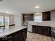 Modern kitchen with dark cabinetry, stainless steel appliances, and a large island at 12723 Pinetop Way, Noblesville, IN 46060