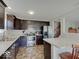 Well-equipped kitchen with stainless steel appliances, dark cabinets, and a breakfast bar for modern living at 12723 Pinetop Way, Noblesville, IN 46060