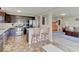 Open-concept kitchen featuring stainless steel appliances and a breakfast bar, seamlessly connected to the living spaces at 12723 Pinetop Way, Noblesville, IN 46060