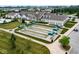 Aerial view of bocce ball courts near the clubhouse and parking, perfect for community gatherings and recreation at 12914 Shiraz Ln, Fishers, IN 46037