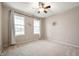 A cozy bedroom with neutral walls, carpeted floor, and large windows providing a view of the outdoors at 12914 Shiraz Ln, Fishers, IN 46037