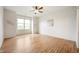 A spacious bedroom with neutral walls, wood flooring, and a ceiling fan at 12914 Shiraz Ln, Fishers, IN 46037