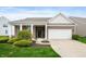 Charming single-story home featuring a brick facade, covered porch, and attached two-car garage at 12914 Shiraz Ln, Fishers, IN 46037