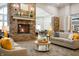 Inviting lobby with a stone fireplace, comfortable seating, and an open floor plan to the dining area at 12914 Shiraz Ln, Fishers, IN 46037
