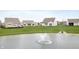 Community pond with fountain and green space, creating a peaceful environment at 12914 Shiraz Ln, Fishers, IN 46037