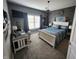 Stylish bedroom featuring a white bed frame, a desk, and warm, neutral tones and a gray accent wall at 1302 Country Creek Cir, Shelbyville, IN 46176
