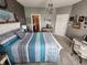 Bright bedroom features a gray accent wall, bed with blue accents, and a small bathroom just off the bedroom at 1302 Country Creek Cir, Shelbyville, IN 46176