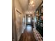 Hallway showcasing hardwood floors, wall decor, and a bench with a patterned cushion at 1302 Country Creek Cir, Shelbyville, IN 46176