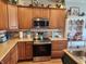 Well-appointed kitchen showcasing modern appliances, granite countertops, and ample cabinet space at 1302 Country Creek Cir, Shelbyville, IN 46176