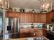 Spacious kitchen with stainless steel refrigerator, wooden cabinets, and granite countertops at 1302 Country Creek Cir, Shelbyville, IN 46176