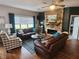 Inviting living room with a stone fireplace, comfortable seating, and hardwood floors at 1302 Country Creek Cir, Shelbyville, IN 46176