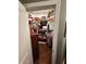 Walk-in closet with ample storage space and a wood floor features wire rack shelving and hanging storage at 1302 Country Creek Cir, Shelbyville, IN 46176