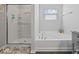 Relaxing bathroom with soaking tub, separate shower, and stylish fixtures at 1305 Bontrager Ln, Shelbyville, IN 46176