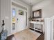 Inviting entryway features a white front door, decorative table, dark wood floors and a neutral rug at 1305 Bontrager Ln, Shelbyville, IN 46176