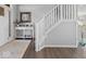Bright entryway features white staircase, view to the kitchen and hard wood floors at 1305 Bontrager Ln, Shelbyville, IN 46176