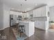 Modern kitchen with white cabinets, granite countertops, stainless steel appliances, and large island at 1305 Bontrager Ln, Shelbyville, IN 46176
