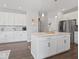 Modern kitchen with large island, white cabinetry, and stainless steel appliances at 1305 Bontrager Ln, Shelbyville, IN 46176
